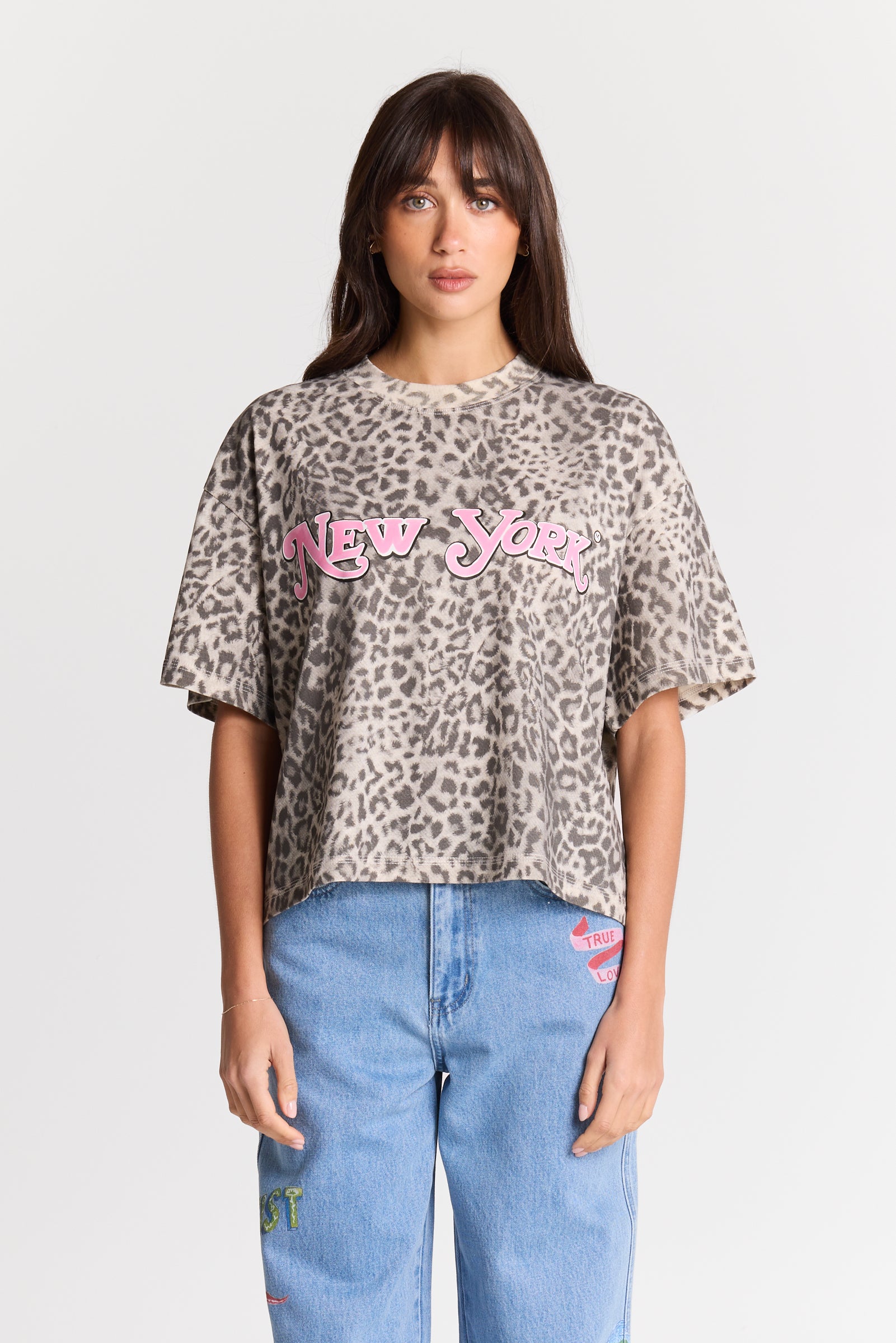 Maku The Label New York Leopard Tee, oversized beige leopard print t-shirt with pink New York embroidery, styled with jeans, front view