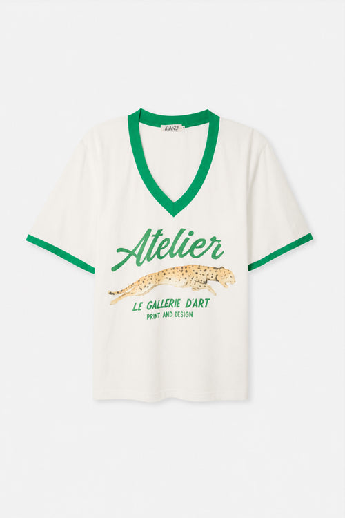 White t-shirt with green accents and text on a white background